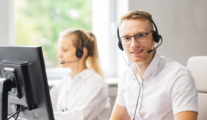 Team of professional support staff working in the office. Colleagues in the workplace solve customer problems. Call center and customer support concept.