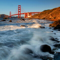 Rocky beach and famous Golden Gate Bridge in San Francisco, California, USA