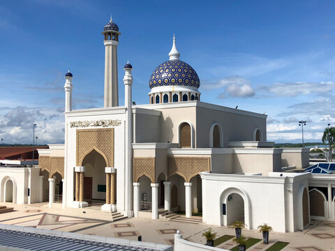 Brunei International Airport Mosque on a blue cloudy sky
background