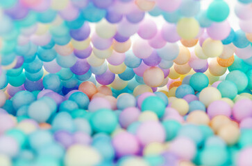 Foam beads of various colors brightly colored abstract background.