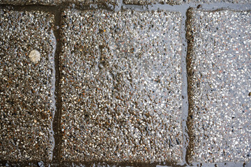 grey paving stones covered with water after rain
