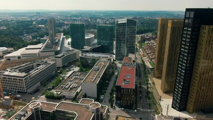 Aerial view of Downtown Kirchberg quarter of Luxembourg City. Court of Justice and Administrative Offices of European Union. Urban Cityscape with Skyscrapers. 4K drone panoramic establishing shot