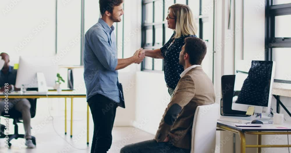 Poster pleased to have you part of the team. 4k video footage of two coworkers shaking hands together in a 