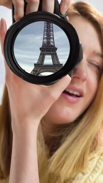 Dream trip to Paris. A girl takes pictures of the Eiffel Tower. Eiffel tower reflection in camera lens. Vertical video for smartphone screen and mobile devices
