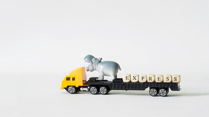 Naklejka na ściany i meble Yellow toy truck with platform, funny hippo and express lettering. Concept of fast express delivery. Concept of transportation of goods. Copy space