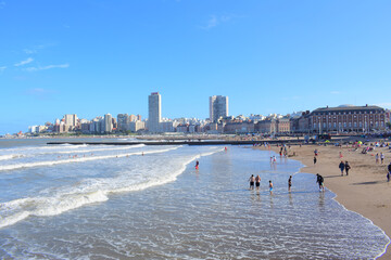 Vacationers at Playa Bristol beach with a cityscape of Mar del Plata in the background in Argentina