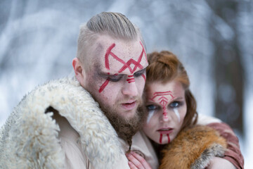 Viking warrior hugging his red-haired female warrior