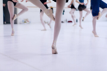 Close up of classic ballet dancers feet's dancing during a lesson - obrazy, fototapety, plakaty