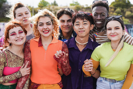Group of young multiracial people wearing trendy retro style clothes while smiling on camera