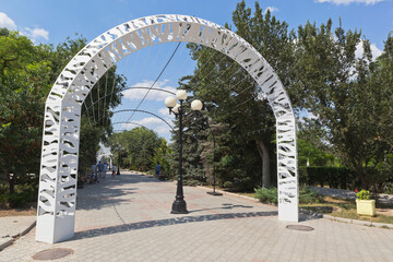 White arch at the entrance to the garden named after Lenin in the city of Evpatoria, Crimea