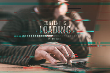 Content is loading, please wait - man browsing internet on laptop computer - obrazy, fototapety, plakaty