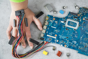 Motherboard and isometric microchip connected to a human hand with wires concept of digital life