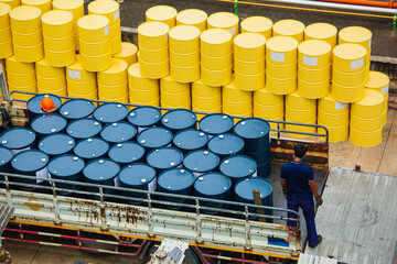 Top view oil barrels forklift truck move for on the transportation truck male worker help