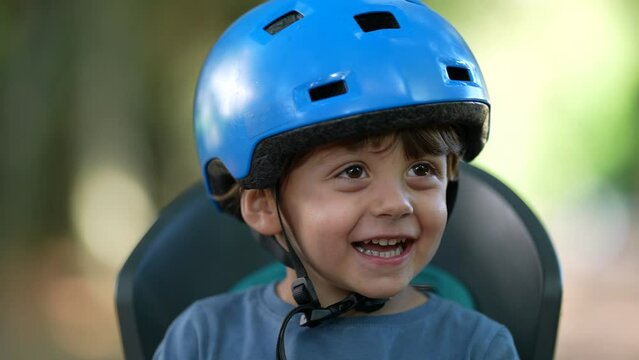 Happy little boy wearing bicycle helmet laughing and smiling