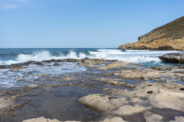 SEA WAVES BREAKING ON ROCKS 
