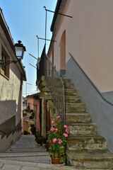 Vertical shot of a narrow alleyway surrounded by elegant modern buildings in San Bartolomeo, Italy
