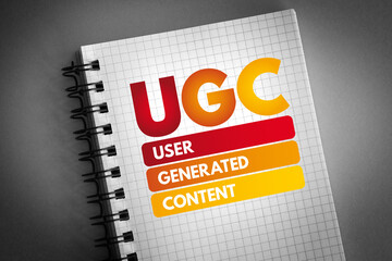UGC - User Generated Content acronym on notepad, business concept background
