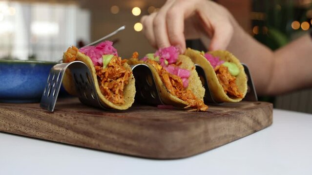 Eating Yucat&aacute;n-Style Shredded Pork Tacos with Achiote (Cochinita Pibil Tacos)