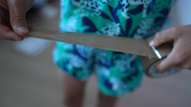 Kid hands using duct tape took