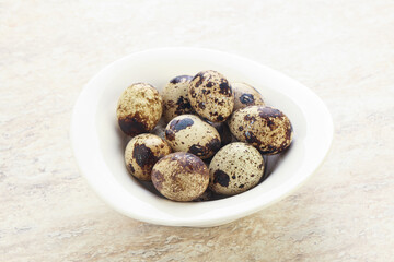 Raw quail eggs heap in the bowl