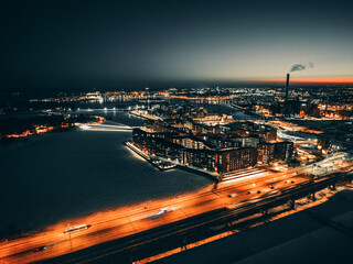 Aerial view of the dense cityscape against the gradient-colored sunset sky captured at late evening