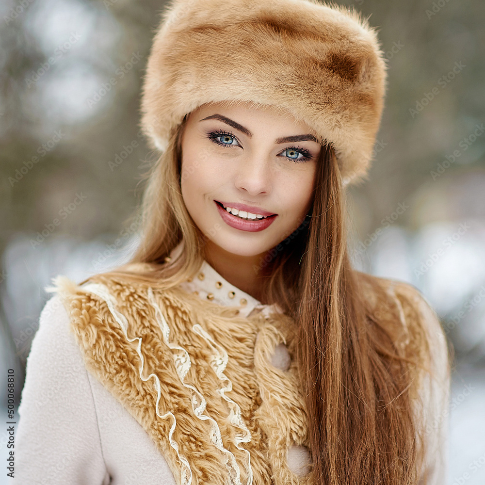 Wall mural Beautiful woman face winter portrait outdoor