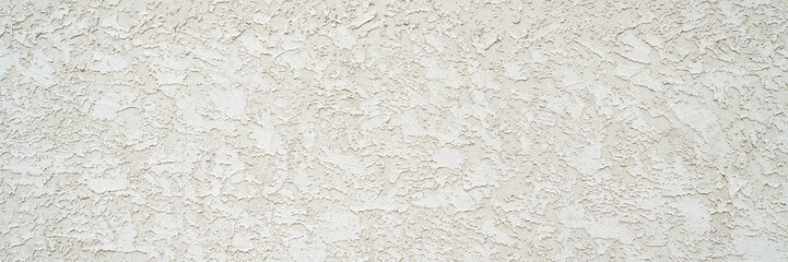 rough stucco texture background on an exterior building wall, panoramic web banner
