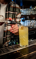 man hand bartender making cocktail on the bar counter