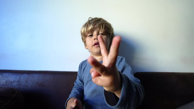 Little boy learning to count with fingers child development