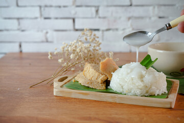 Sticky Rice with Egg Custard. Thai desserts on a wooden table.