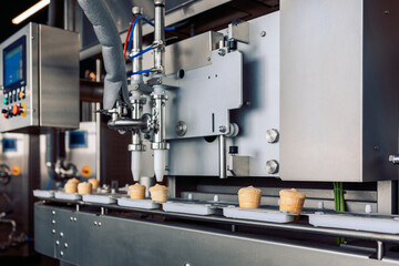 Manufacturin for automatic production of ice cream cones. Conveyor belt in waffle cups, creme brulee. Sweets modern factory. Food dairy industry, automated technology equipment and engineering concept
