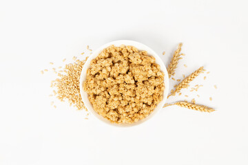 wheat spike next to granola bowl