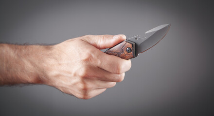 Male hand holding a hunting knife.