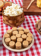 Typical brazilian june festival food over plaid fabric. Festa junina