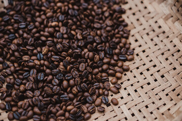 Roasted coffee beans are piled up in Thai wicker baskets.