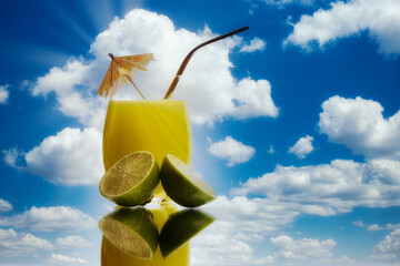Freshly Squeezed Sour Lemon Juice cocktail isolated on a Cloud background on a reflective surface ...