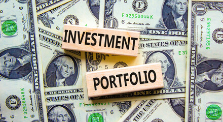 Investment portfolio symbol. Wooden blocks with concept words Investment portfolio on beautiful background from dollar bills. Business investment portfolio concept. Copy space.