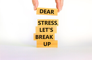 Stress break up symbol. Concept words Dear stress let is break up on wooden blocks. Businessman hand. Beautiful white table white background. Business motivational stress break up concept. Copy space.