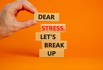 Stress break up symbol. Concept words Dear stress let is break up on wooden blocks. Businessman hand. Beautiful orange background. Business motivational stress break up concept. Copy space.
