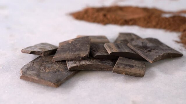 Chocolate liquor is pure cocoa mass in solid or semi-solid form. It is used very often as a way to make better industrial chocolate compounds or recipes with more chocolate flavor. 4k footage