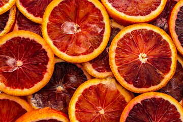 Fruit background with blood oranges and ice, delicious sweet fruit, top view