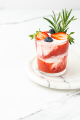 Delicious healthy breakfast, strawberry smoothie with natural yogurt and blueberries and rosemary