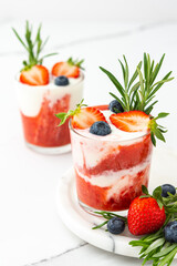 Delicious healthy breakfast, strawberry smoothie with natural yogurt and blueberries and rosemary
