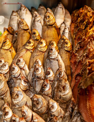 Fish shop: close-up of smoked and dried fish laid out in a shop window. 