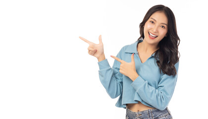 Beautiful young Asian woman pointing up to copy space and looking at camera with smile face and happy Pretty girl act like a satisfied product, use for advertising with isolated on white background