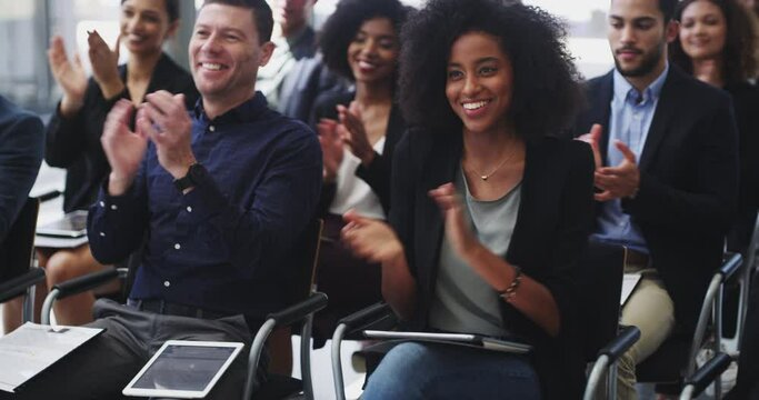 Applauding their success. 4k video footage of businesspeople applauding while attending a conference.