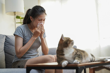 Animal allergy concept, fur and pet allergic woman cover her nose while cough and sneeze and avoid...
