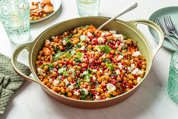 Chickpea salad with roasted yams, spinach, pomegranate, feta cheese, coriander, sesame seeds. 