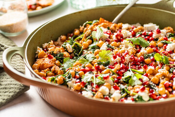 Chickpea salad with roasted yams, spinach, pomegranate, feta cheese, coriander, sesame seeds. 