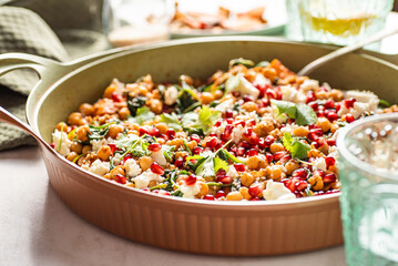 Chickpea salad with roasted yams, spinach, pomegranate, feta cheese, coriander, sesame seeds. 